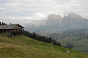 hikers resting on hillside in Dolomite Mtns, Italy